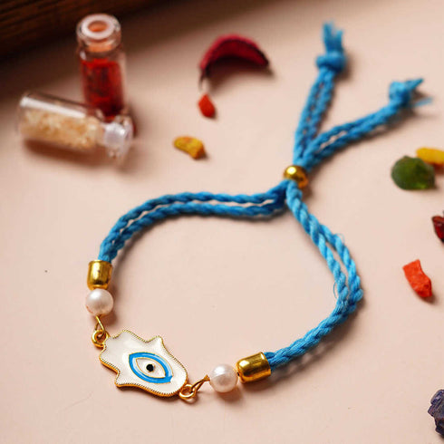 White Hamsa Hand Sky-Blue Thread Rakhi - Uncommongifts.in