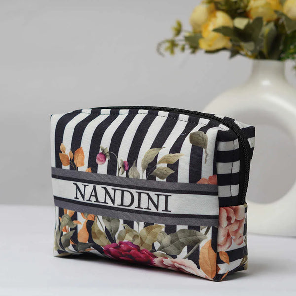 Floral and striped pouch with 'Nandini' branding on a light background