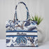 Floral patterned handbag with 'Reshma' branding on a light background