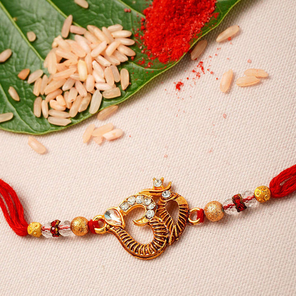 Gold Om Red Thread Rakhi - Uncommongifts.in