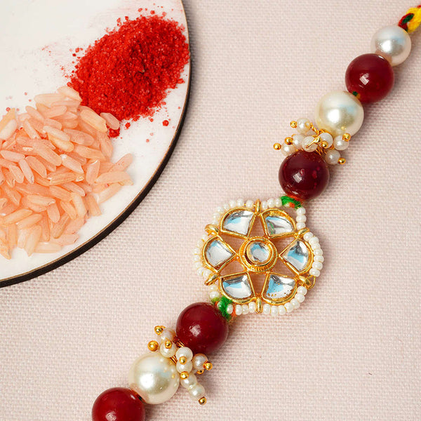 Maroon & White Flower Pearl Rakhi - Uncommongifts.in